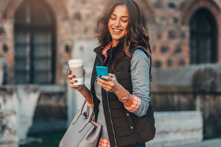 woman wearing gilet holding mobile
