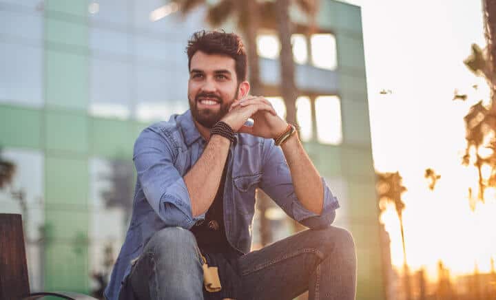 smiling guy sitting outside in sun