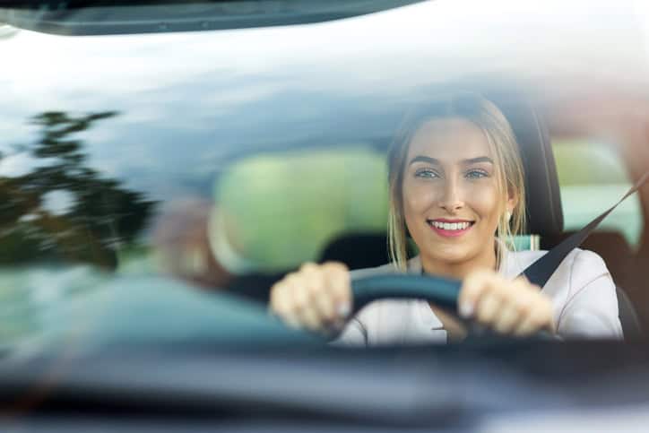Woman at the wheel of her car.