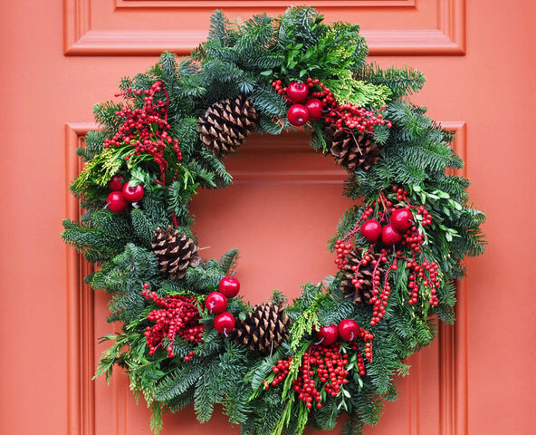 Christmas wreath on red front door.