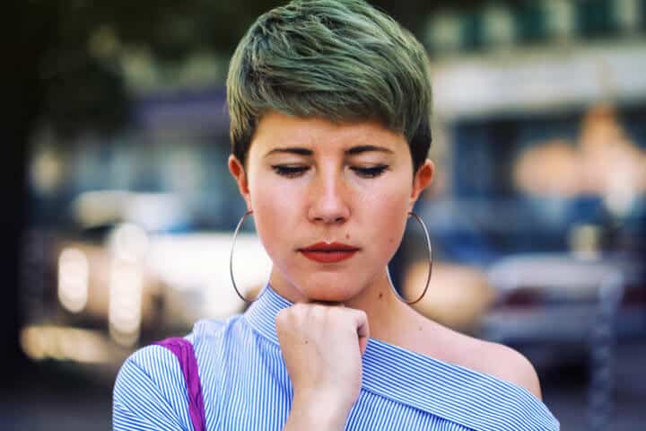 woman with green hair upset