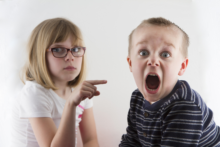 Boy got caught and now is in trouble and making a funny face.