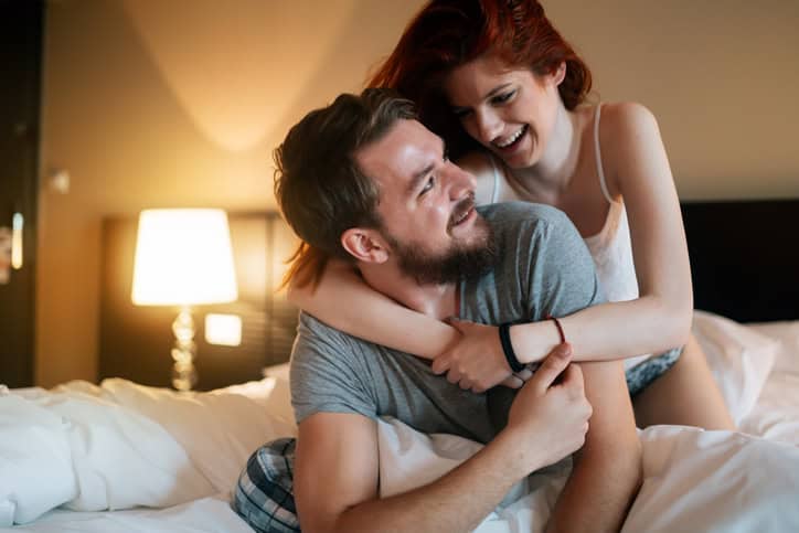 Sensual cute young couple in bed cuddling