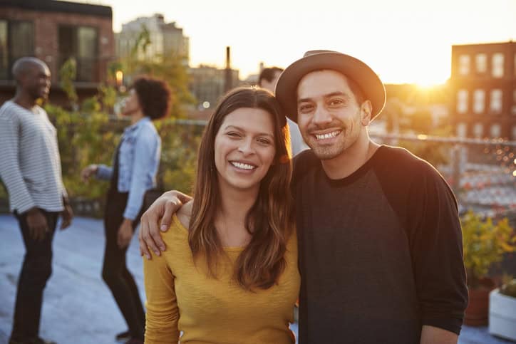 couple outside on rooftop sunset
