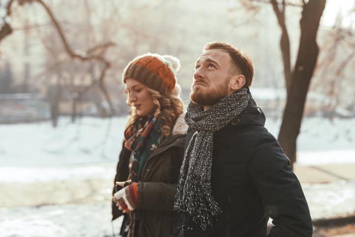 Depressed man walking next to his girlfriend