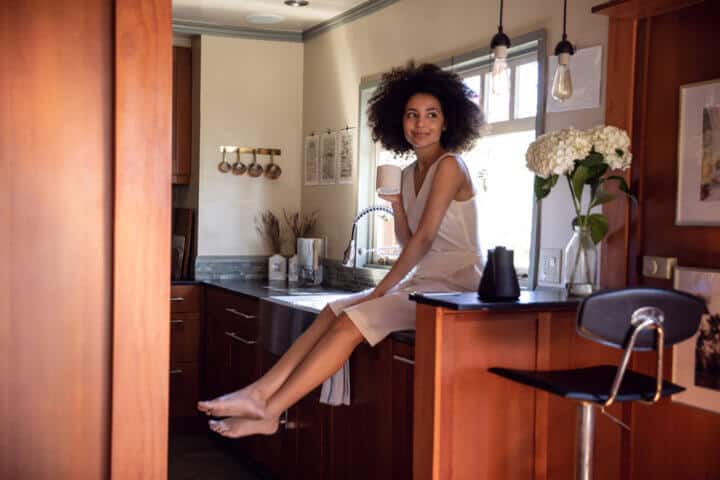 smiling woman sitting on counter