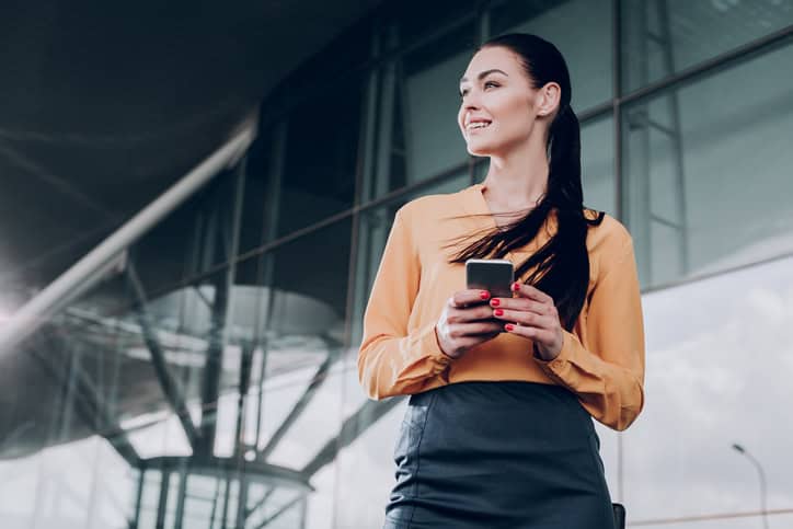 brunette woman holding a mobile phone