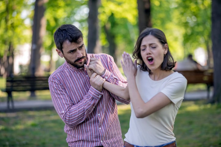 young couple arguing in the park
