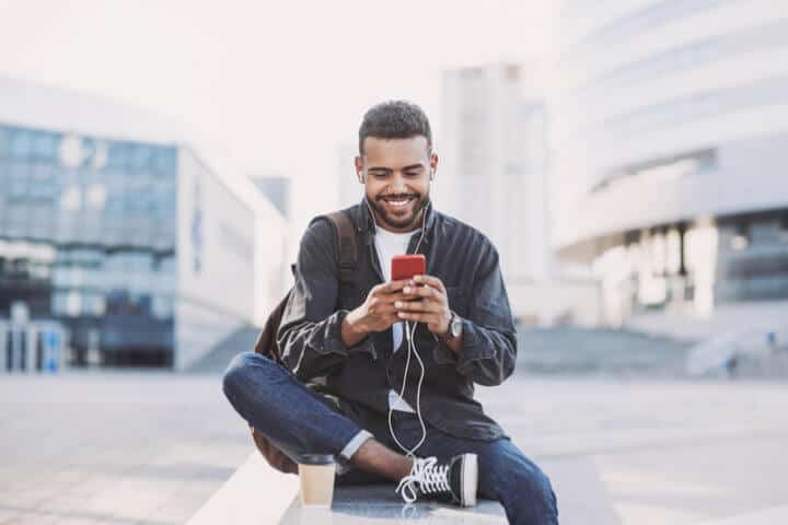black guy texting on a wall