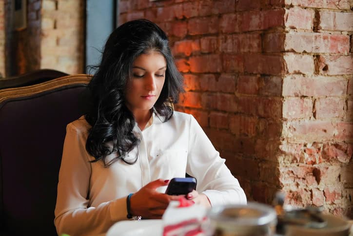 Woman drinks mulled wine in coffee shop.
