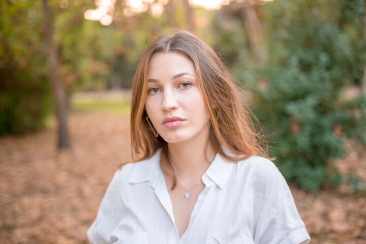 young woman outside foliage