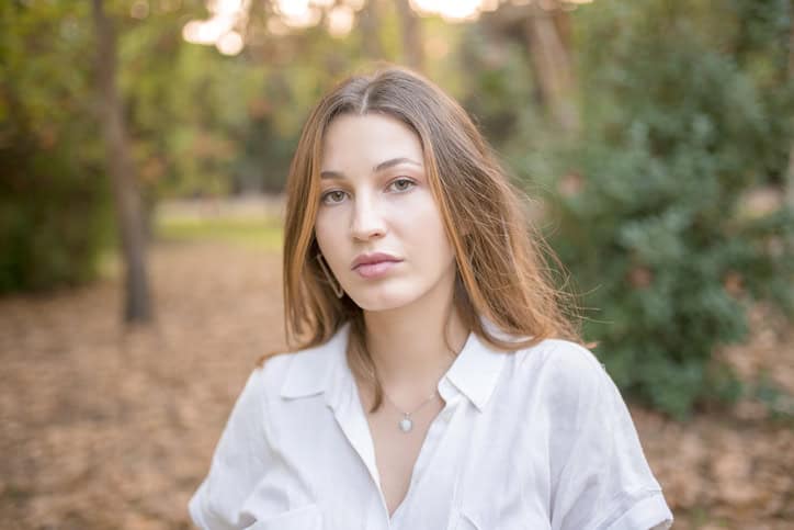 young woman outside foliage