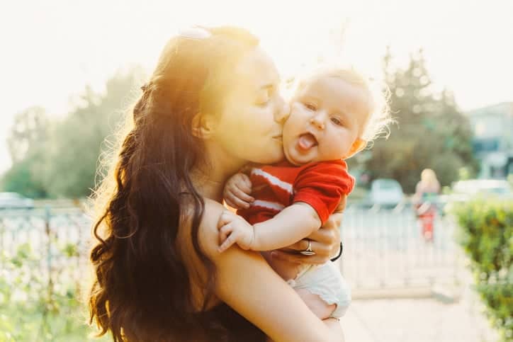 Young Caucasian woman walking with baby