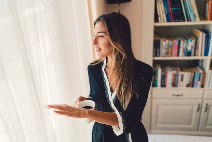 Relaxed woman drinking coffee at home