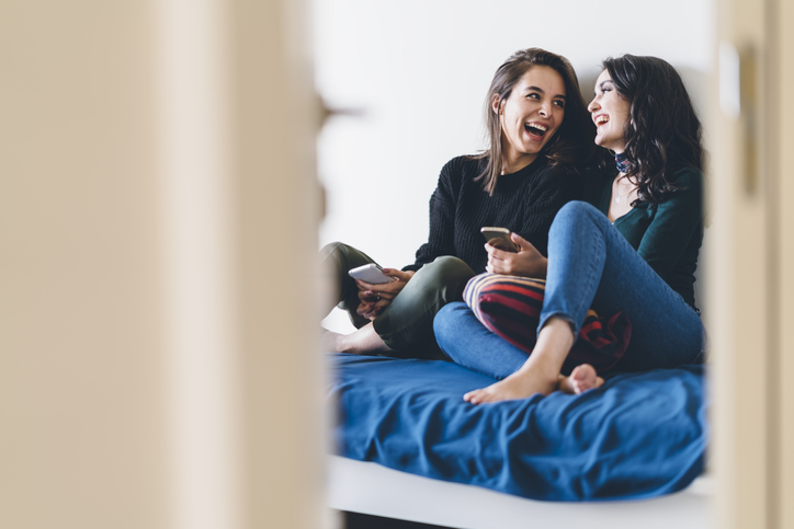 two friends laughing at home