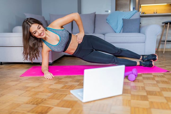 woman doing at home virtual workout.