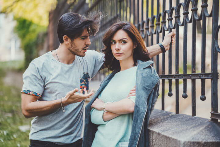 couple arguing outside railings