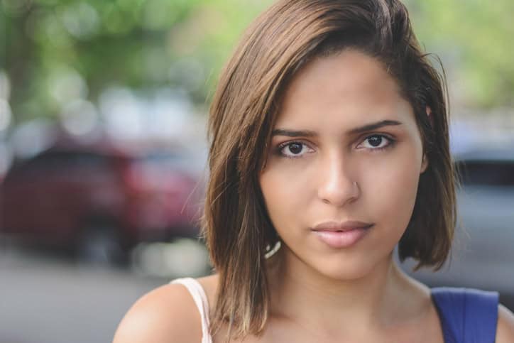 dark haired woman looking serious