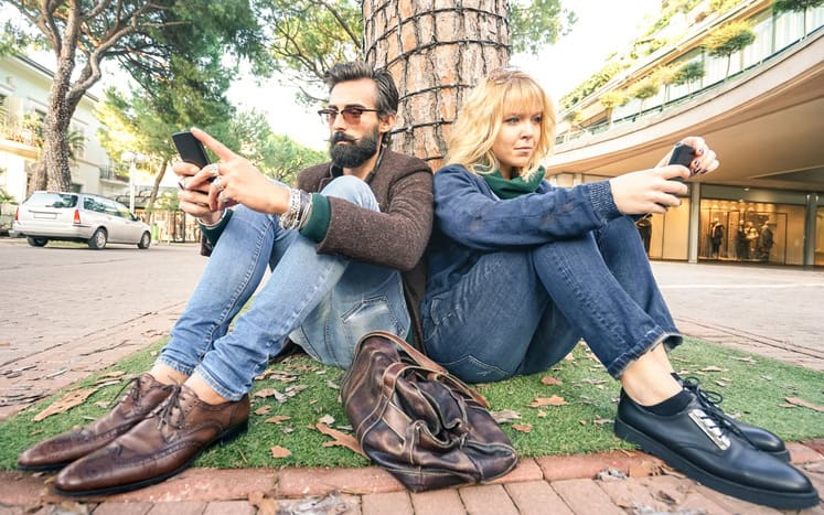 couple sitting back to back