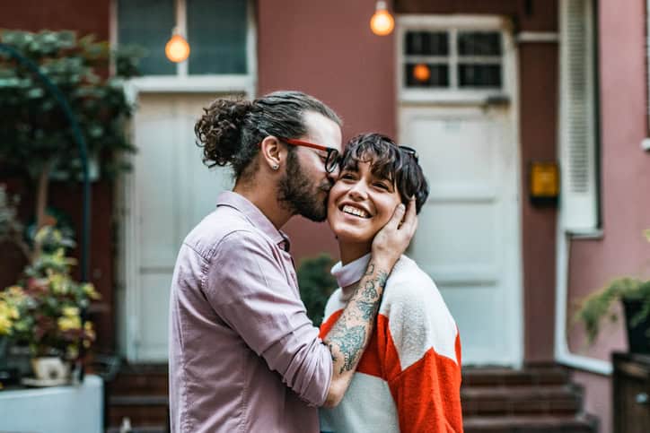 happy young couple smiling in the street