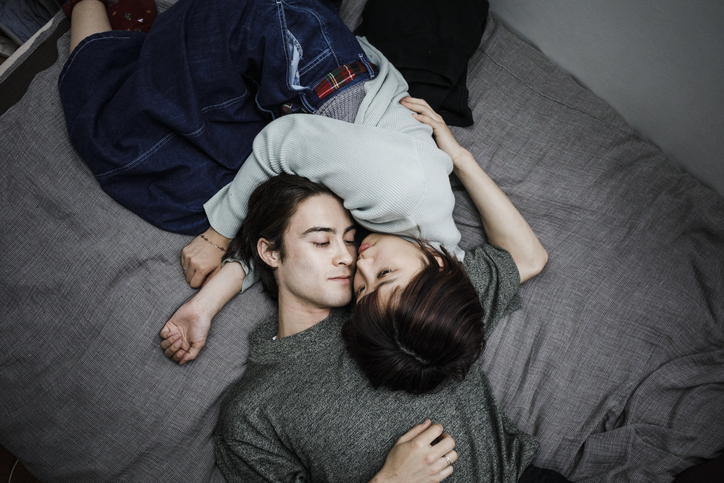 asian couple laying down