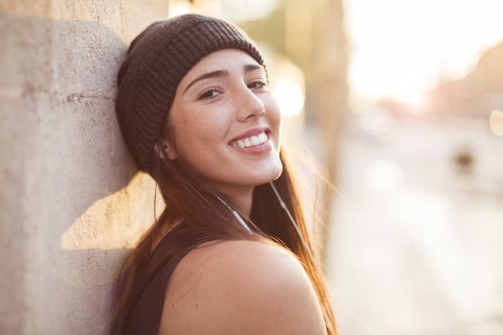smiling woman with a hat on