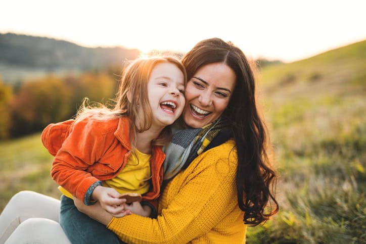 young mother with daughter smiling