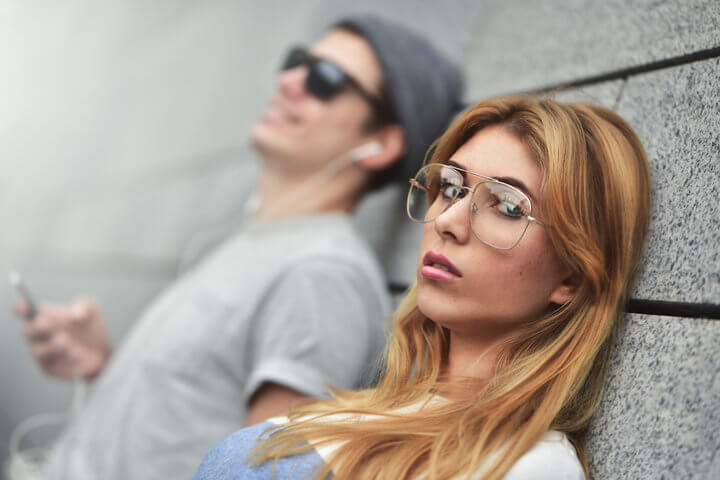 couple leaning up against a wall together