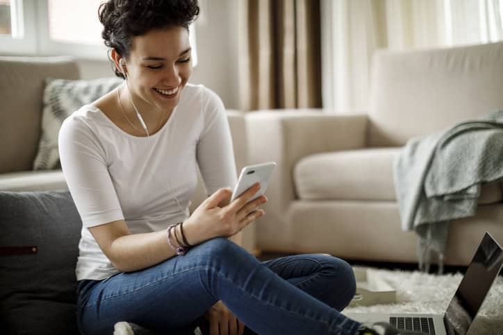 woman sitting at home texting