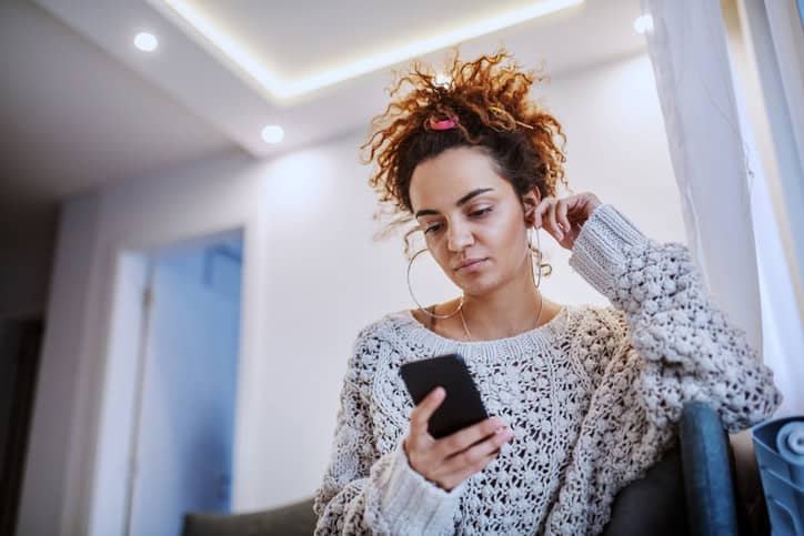Attractive Caucasian tanned brunette with mobile