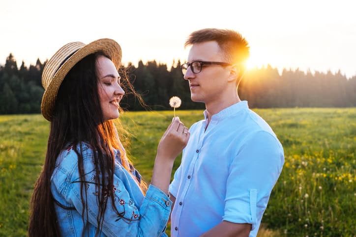 two people standing in a field