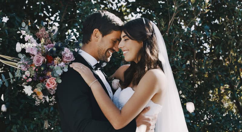 Young newlywed couple dancing together on their wedding day.