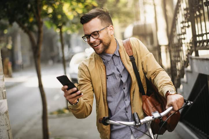 attractive man on bike texting
