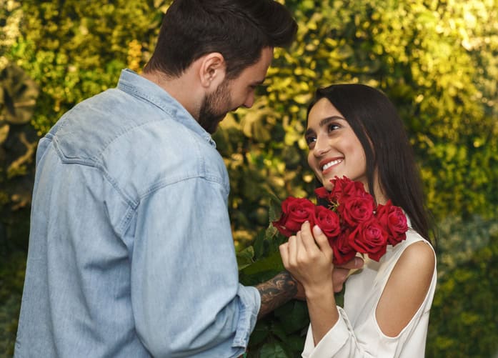 man giving a woman flowers