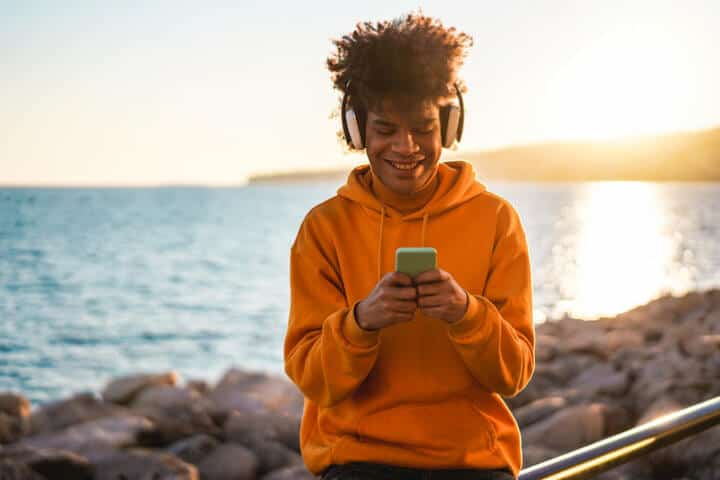Man listening to music playlist with smartphone.