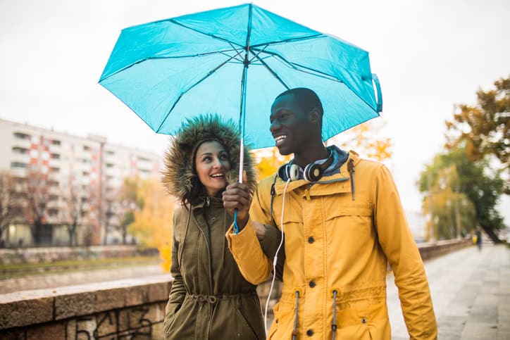 mixed race couple under an umbrella