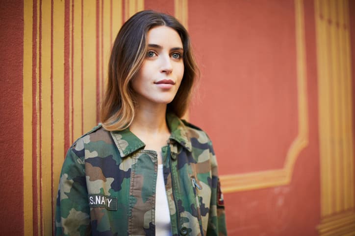 girl in camo jacket smiling