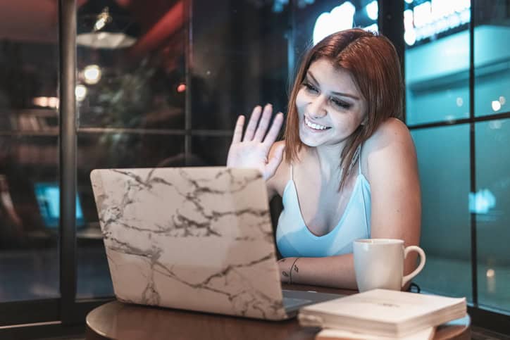 woman waving to someone online