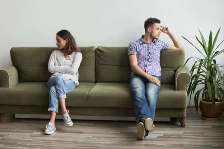 couple on couch in a fight