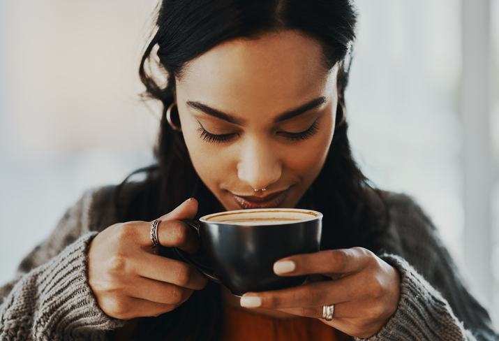 Young woman having a coffee break at home.
