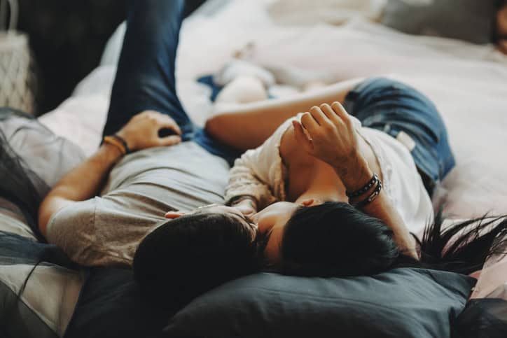 couple laying on a bed