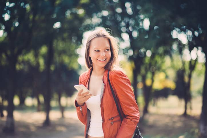 smiling happy woman orange jacket