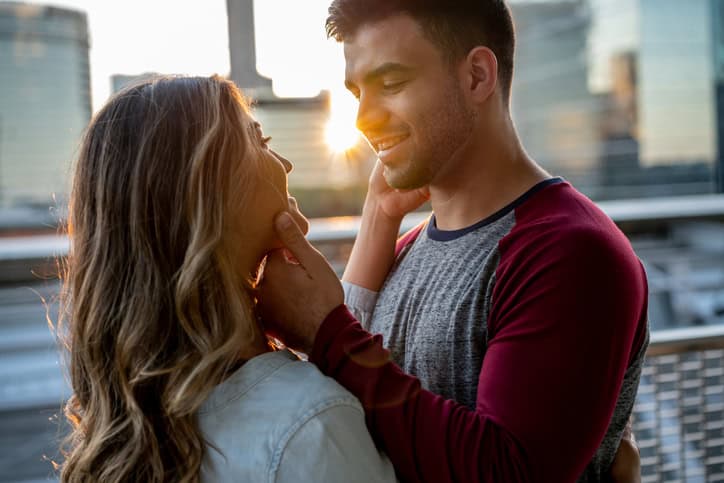 couple being intimate in the sunset