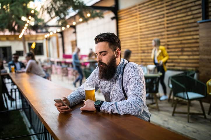 guy texting at restaurant