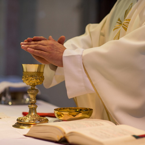 Priest with the body and blood of Christ.