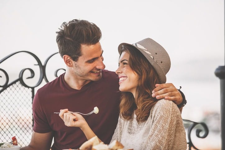 couple outside eating smiling