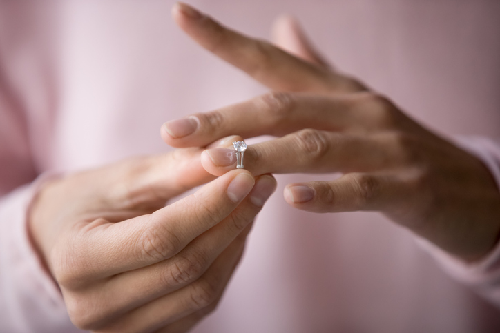 Woman removing her wedding ring.