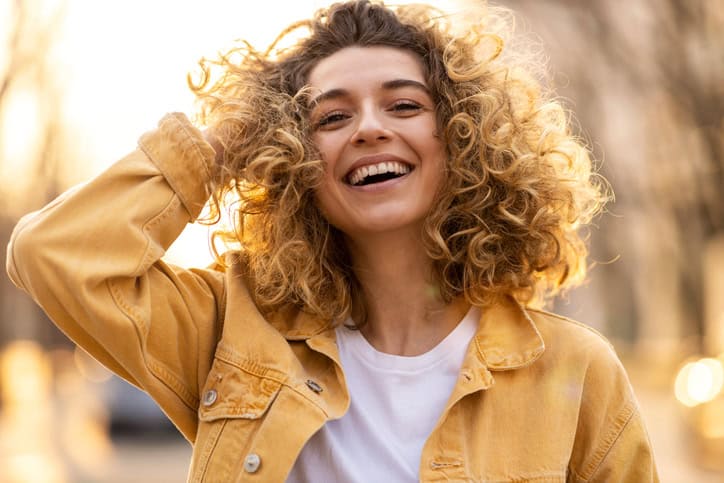 curly haired woman smiling