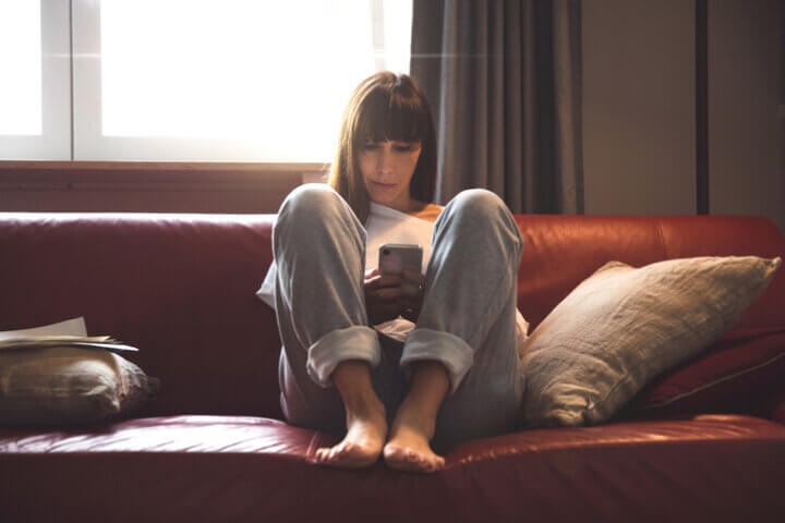 Pensive woman sitting on the sofa relaxing