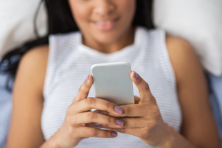 Close-up of woman texting on her phone.